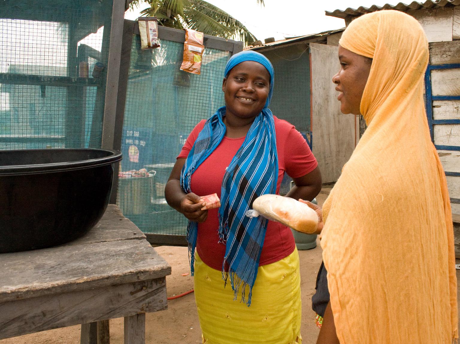 A market stall owner talks to a customer