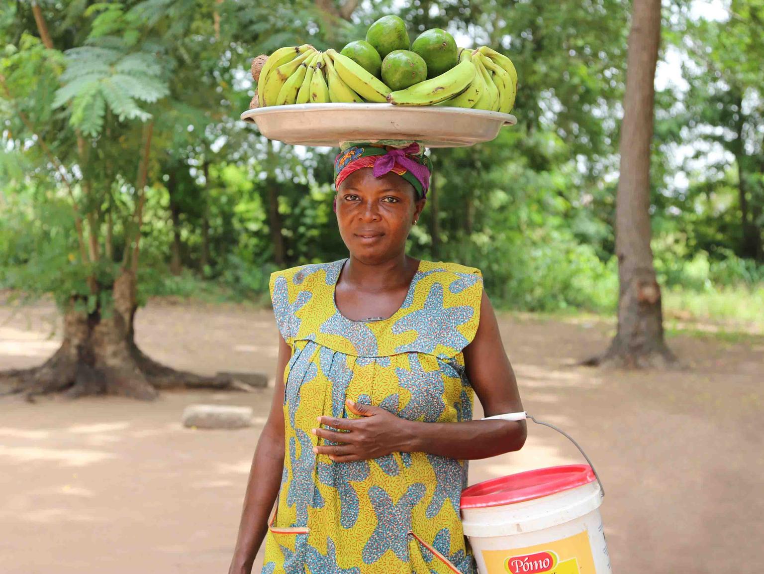 woman carries fruit on her head